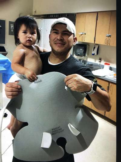 Dad holding daughter - Pediatric Position Holder & Immobilizer >